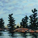 A rocky island with a few white pines in an Ontario lake