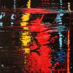 Neons on a rainy night create an abstract piece of art in primary colours at the intersection of Young and Queen Street in Toronto. Red, yellow and blue splashes paint the asphalt.
