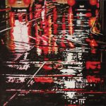 Tracks of cars and parallels lines of streetcars paint patterns on the slick wet streets. Car lights and traffic lights leave patches of yellow and red on the surface.
