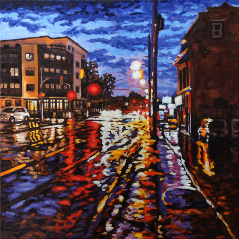 Wet street after heavy rain reflects red, yellow, orange, purple and white lights from traffic and commercial signs. On the left we see a modern four-story building, opposite an older building, both in orange and brown hues. The sky is filled with dark blue clouds, and breaking up, showing light blue and light purple
