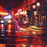 City lights on a rainy night set the town aglow, wit red, orange, purples and pinks