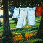 shirts and towels hang to dry on clothline between two trees